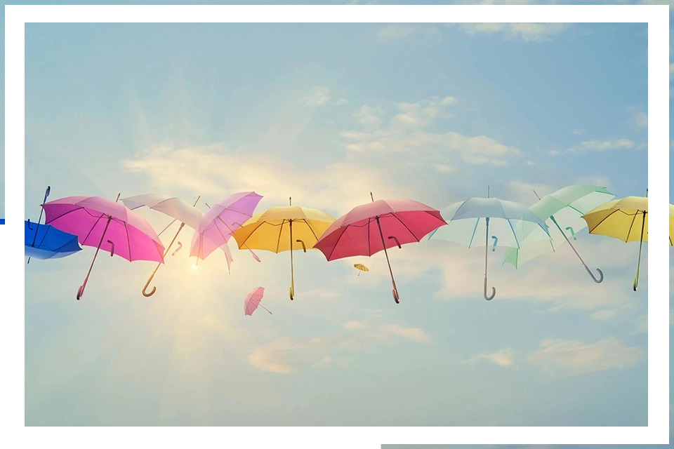 A group of umbrellas flying in the sky.