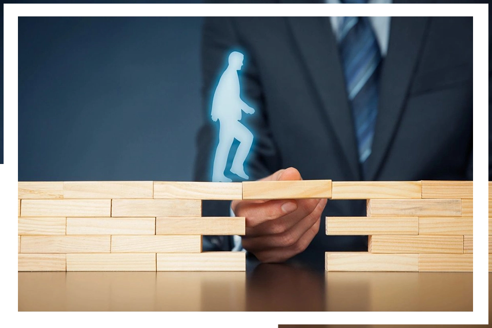 A person holding onto some blocks to build a wall