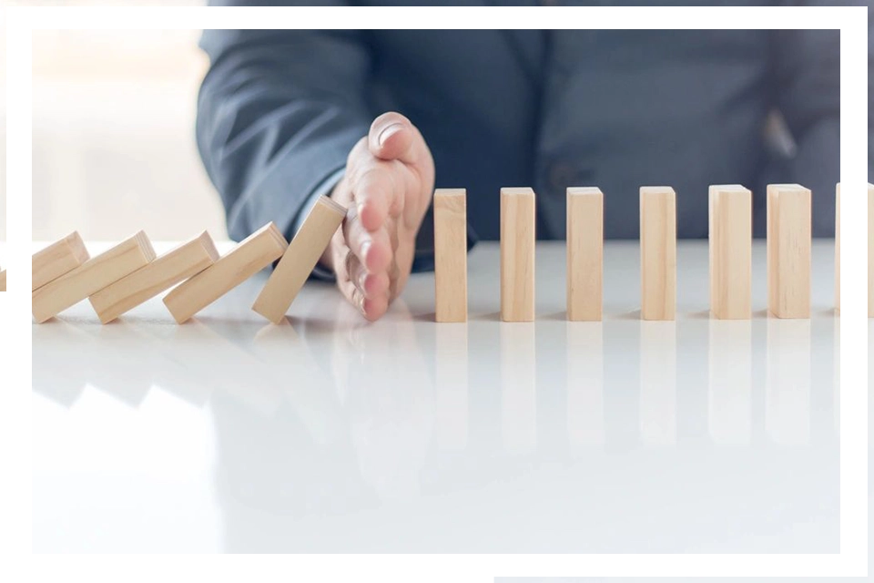 A person is playing with wooden blocks on the table