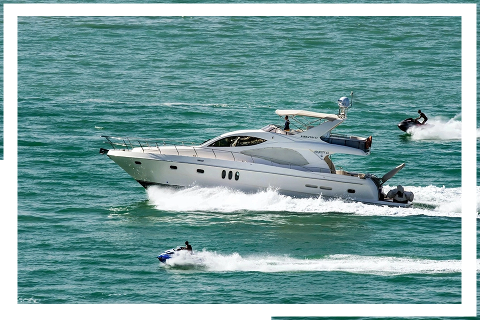 A boat is in the water with another boat behind it.