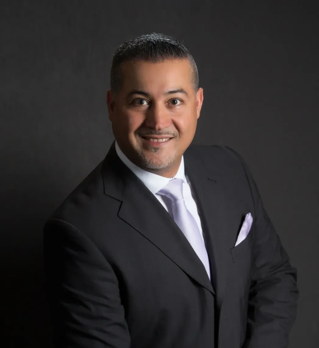 A man in a suit and tie standing.